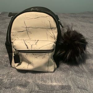 cute black and white mini backpack with keychain attached!